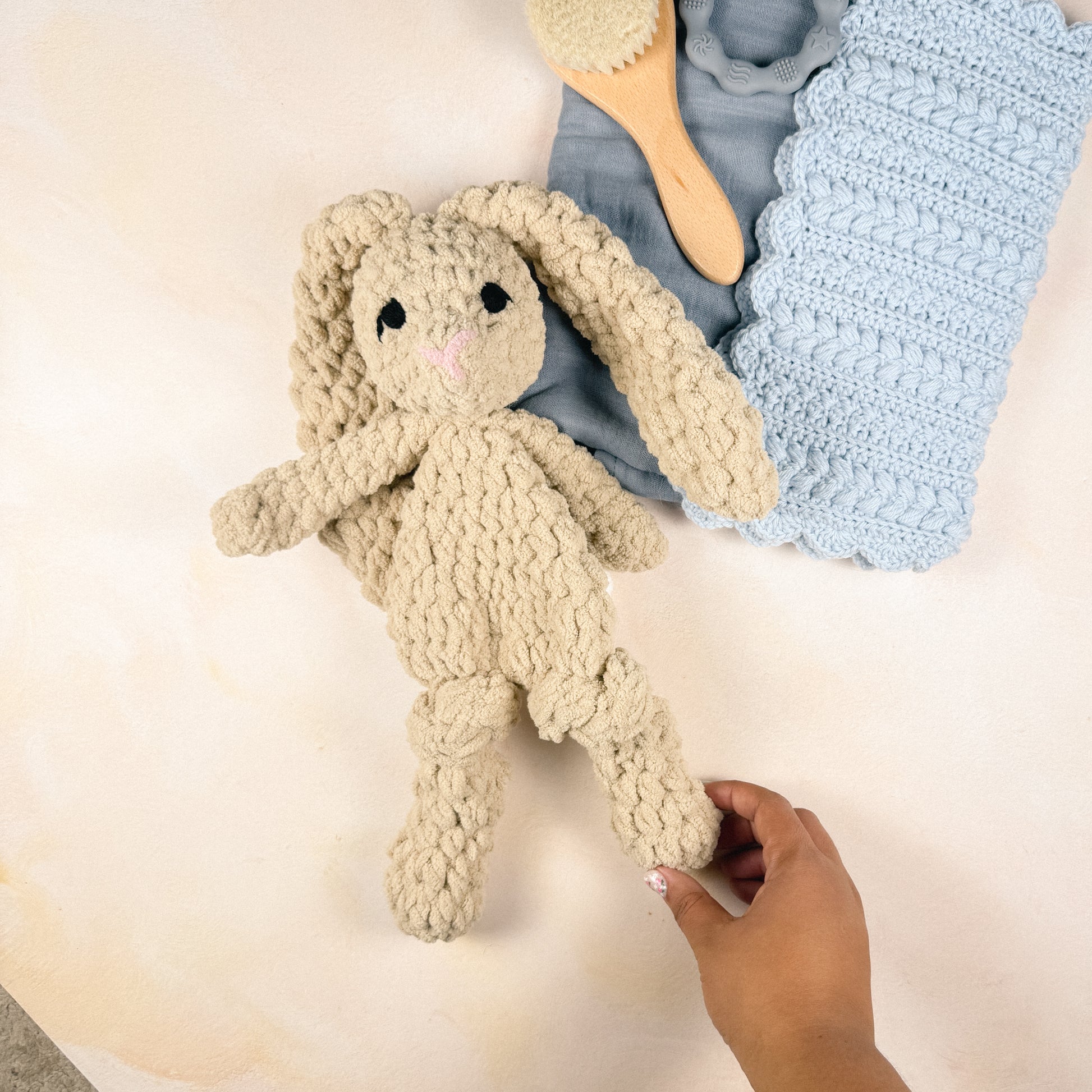 Hand holding the plush bunny included in the Keepsake Edit to show size and scale.