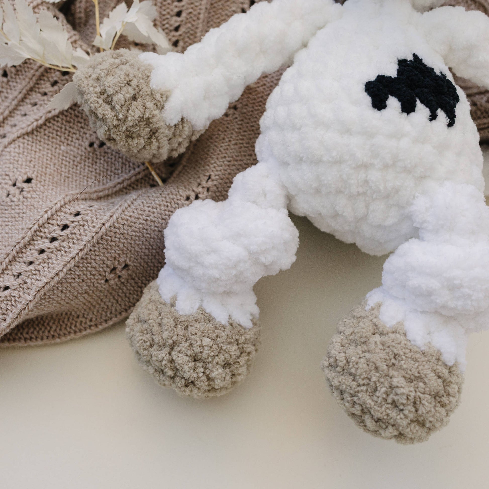 Close-up of cow plush fabric and stitched details.