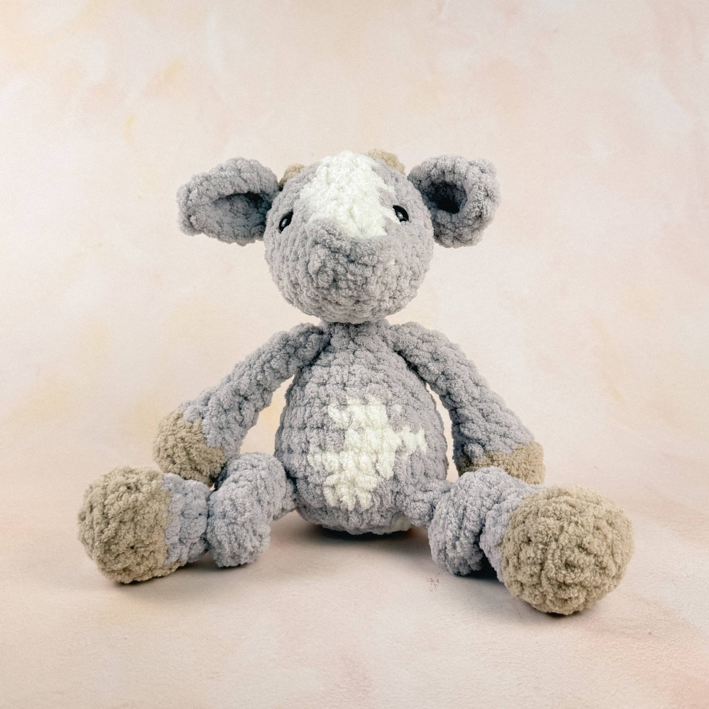 Goat plush shown on a neutral background to display size and texture.