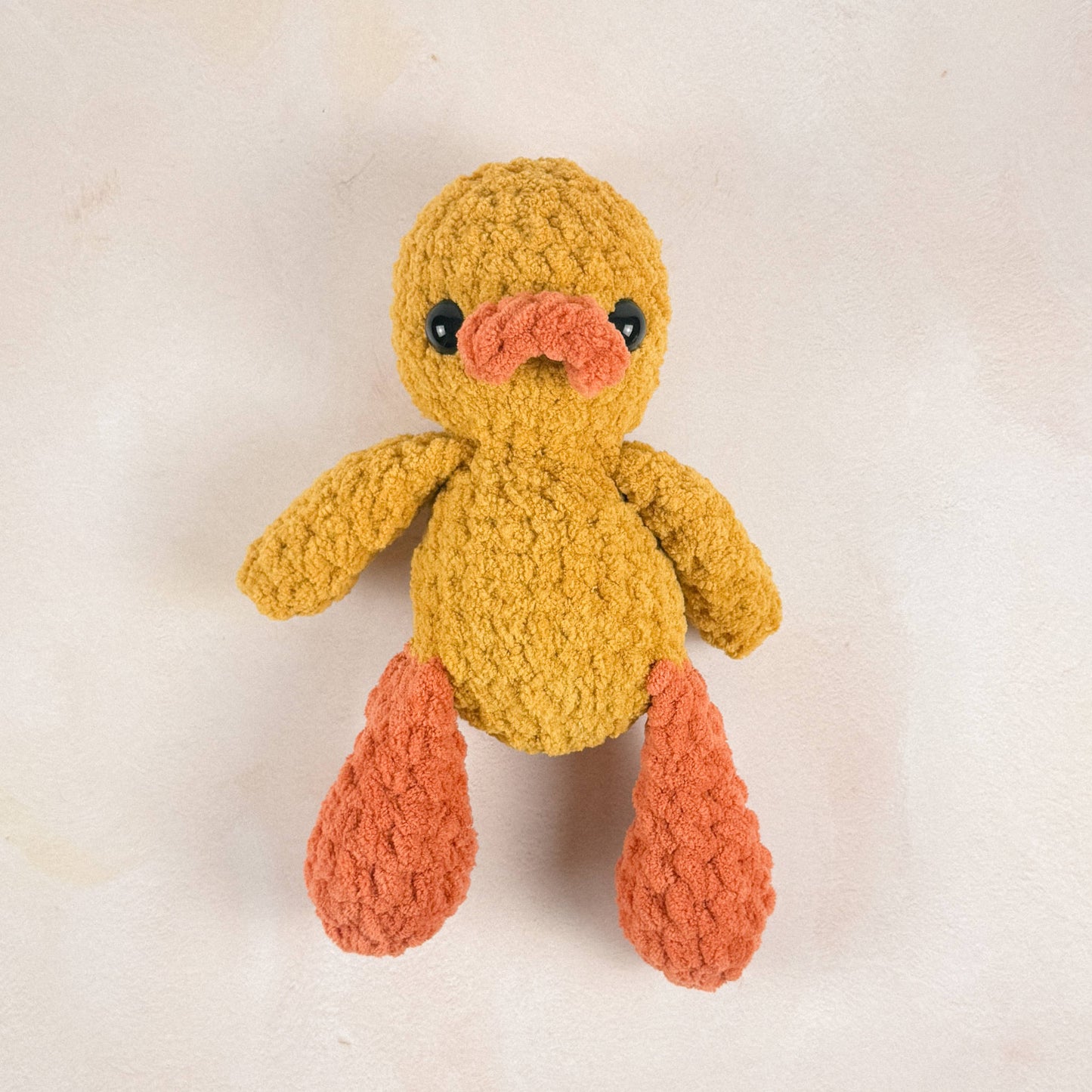 Duck plush shown on a neutral background to display size, shape, and texture.